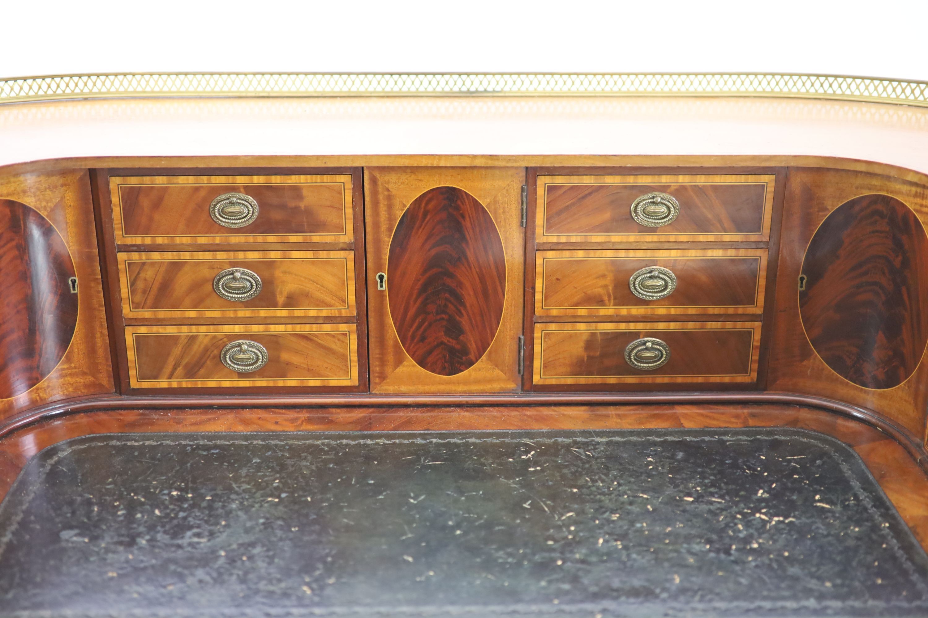An Edwardian Sheraton revival satinwood banded mahogany Carlton House desk, W.138cm D.65cm H.104cm